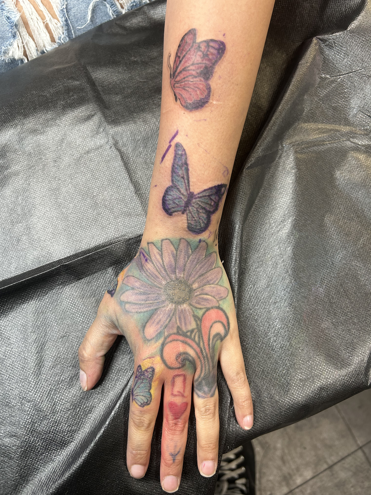 Consult photo — faded hand tattoos assessed for cover-up planning, Las Vegas, Work of Art Tattoo & Piercing, Las Vegas