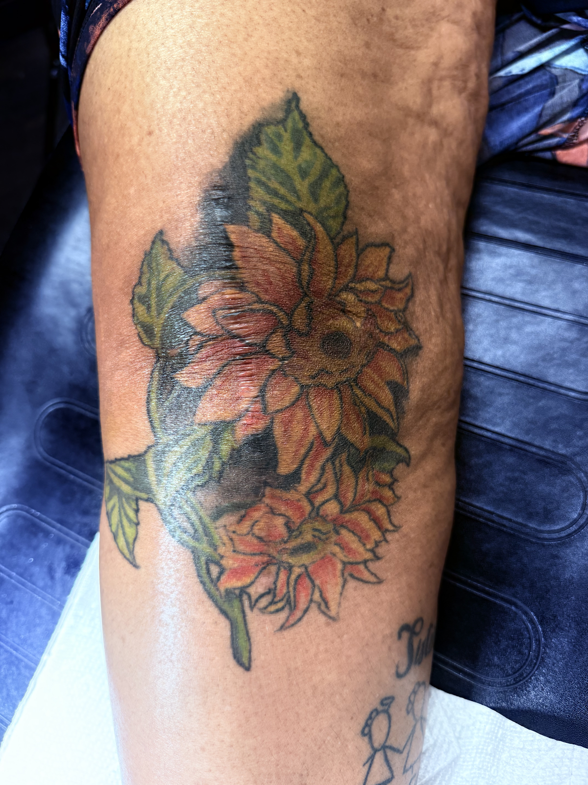 Leg tattoo cover up — sunflower over dense black ink, Work of Art Las Vegas, Work of Art Tattoo & Piercing, Las Vegas