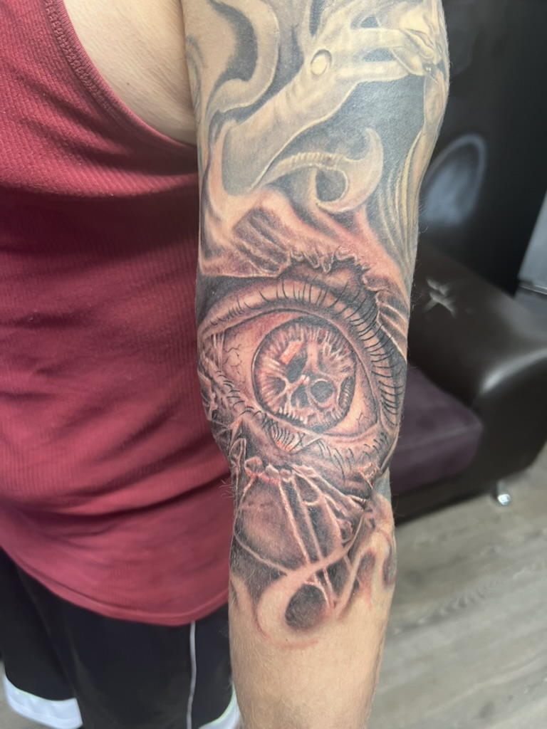 Fresh black and grey all-seeing eye skull elbow tattoo by Joshua Cole, Las Vegas, Work of Art Tattoo & Piercing, Las Vegas