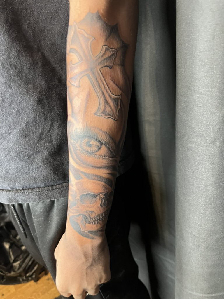 Full inner arm one-year healed cross eye skull tattoo by Joshua Cole, Las Vegas, Work of Art Tattoo & Piercing, Las Vegas