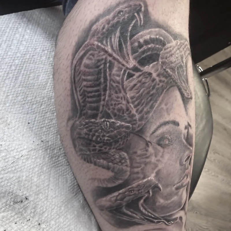 Black and grey Medusa realism tattoo with detailed snake hair — Work of Art Tattoo Las Vegas