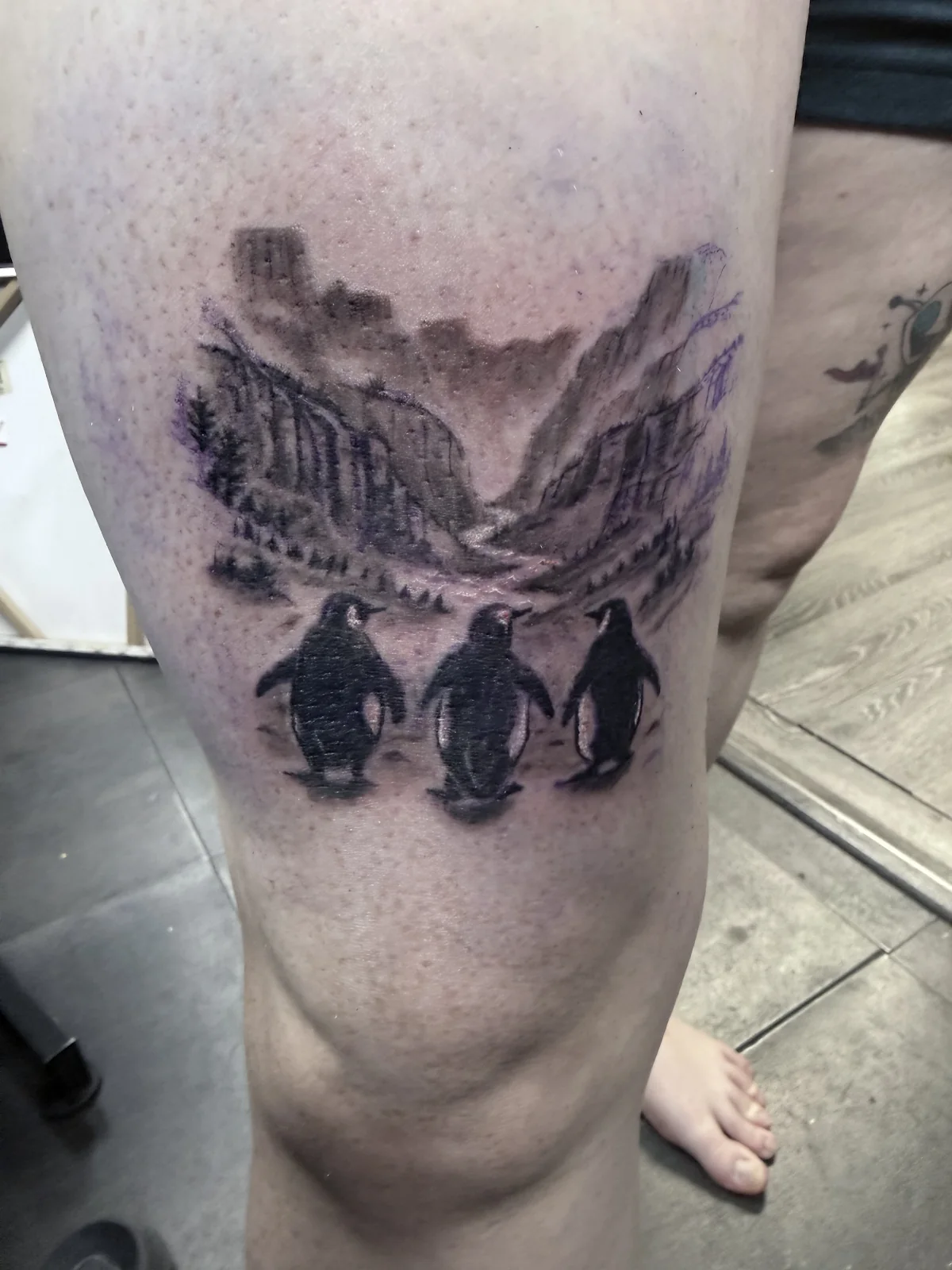 Black and grey penguin landscape realism tattoo — Work of Art Tattoo Las Vegas