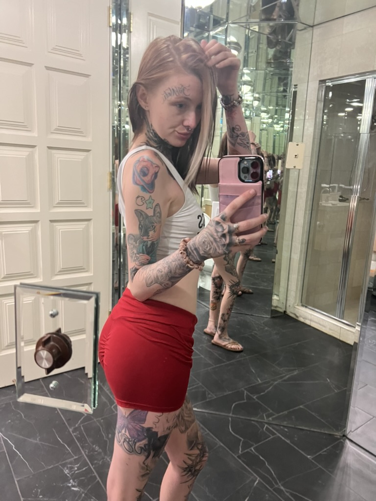 Heavily tattooed client mirror selfie showing rose hand tattoo and purple butterfly offsite…, Work of Art Tattoo & Piercing, Las Vegas
