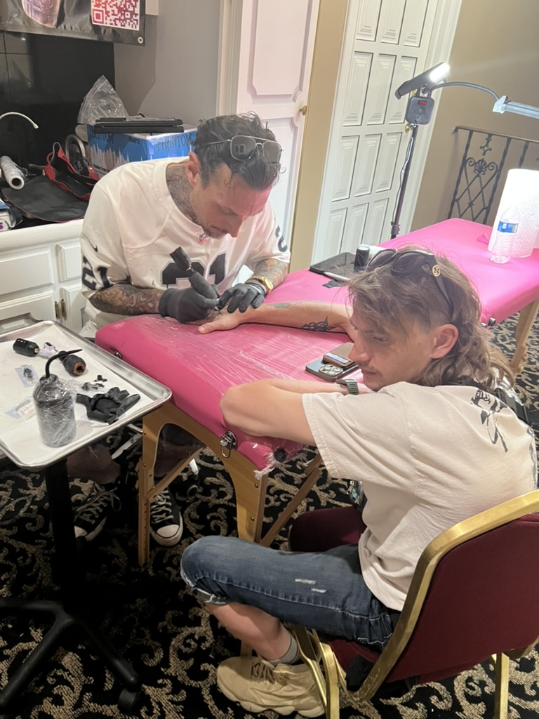 Joshua Cole Reviewing Tattoo Designs with Client at Portable Offsite Station, Work of Art Tattoo & Piercing, Las Vegas