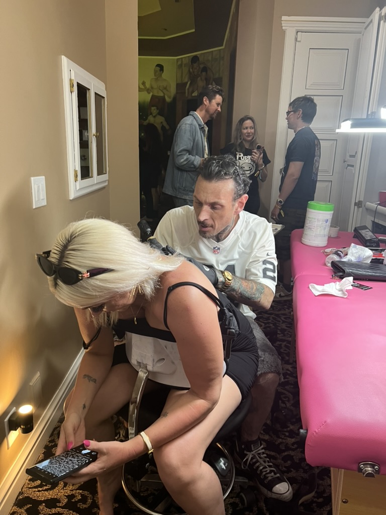 Joshua Cole tattooing at private event — portable setup with professional lighting, Work of Art Tattoo & Piercing, Las Vegas