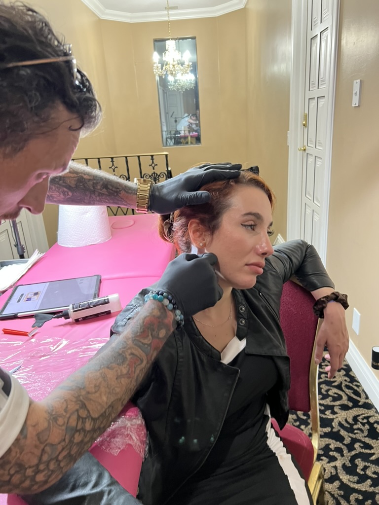 Joshua Cole tattooing client's hand at private residence — offsite booking Work of Art Las Vegas, Work of Art Tattoo & Piercing, Las Vegas