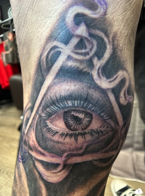 Black and grey all-seeing eye in triangle with smoke ribbons — Joshua Cole, Work of Art Las Vegas, Work of Art Tattoo & Piercing, Las Vegas