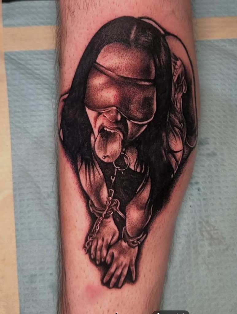 Realistic blindfolded woman with collar, chain and wrist shackles in black-grey ink — Joshua…, Work of Art Tattoo & Piercing, Las Vegas