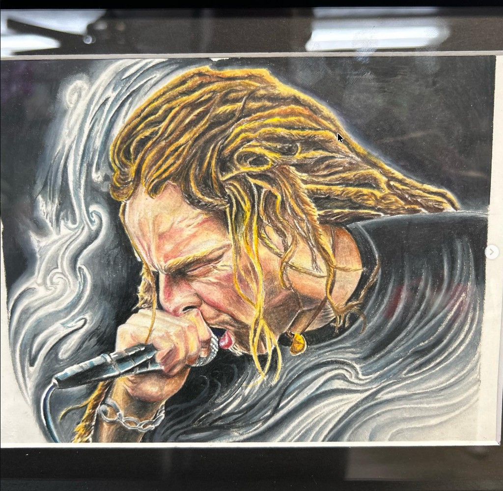 Framed color drawing of blonde dreadlocked singer screaming into a mic with smoke swirl — Joshua…, Work of Art Tattoo & Piercing, Las Vegas