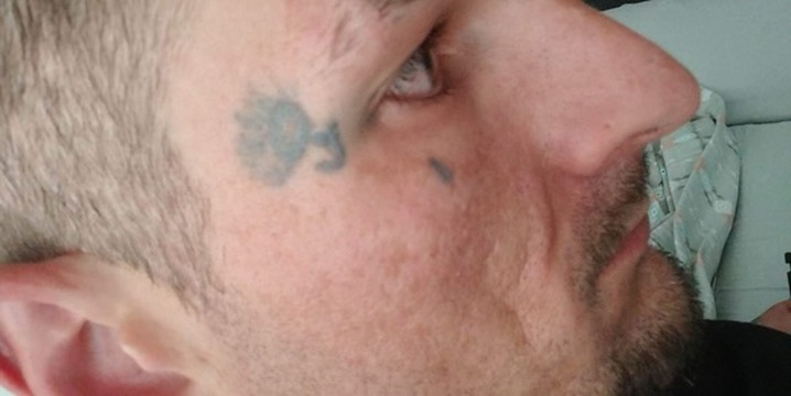 Side profile showing small fine-line temple and cheek tattoos on a man's face. — Joshua Cole…, Work of Art Tattoo & Piercing, Las Vegas