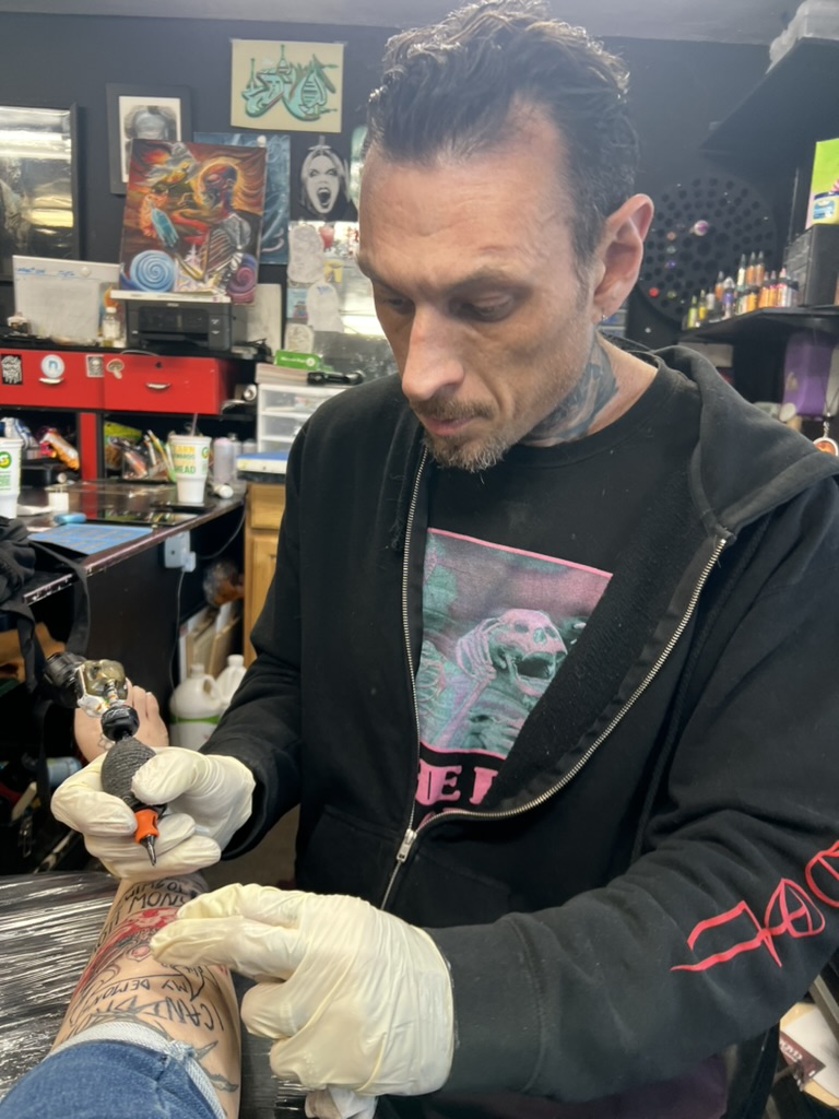 Joshua Cole at work on custom illustrative tattoo — Work of Art Las Vegas, Work of Art Tattoo & Piercing, Las Vegas